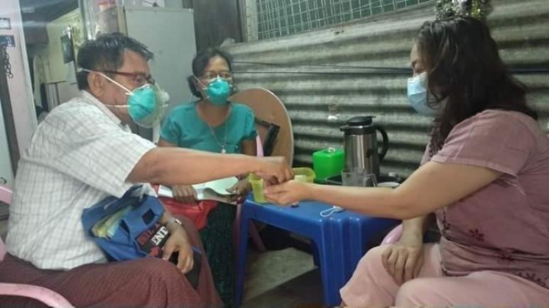 Daw Naw Ro Da taking anti-TB drugs from the PGK volunteer on a daily checkup visit. Photo: Pyi Gyi Khin